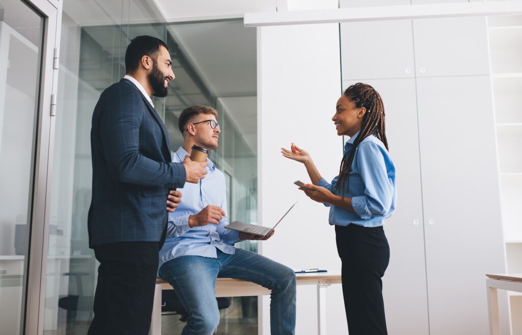 Multiracial male and female colleagues talking about technology investment